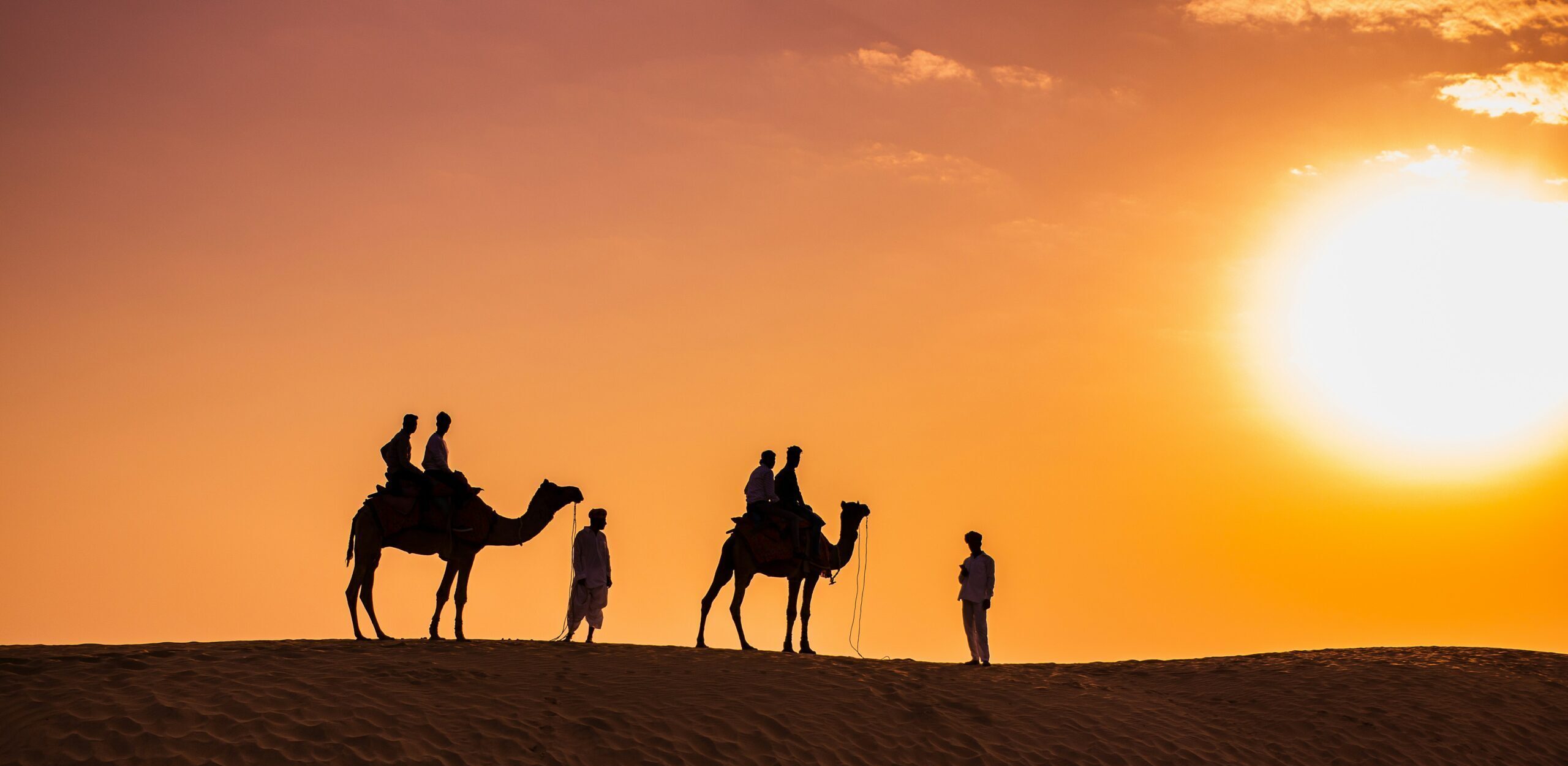 A premium 4x4 vehicle climbing towering red sand dunes on the Best Desert Safari Dubai excursion by HFT Tourism.